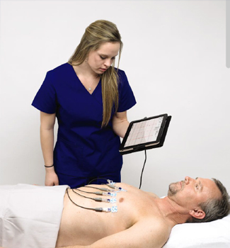 Clinician placing ECG electrodes on a patient while viewing the trace on a tablet